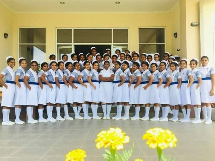 Large group of nursing students in uniform outside their training hospital